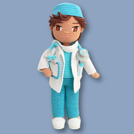 Dr. Thomas crochet doll pattern - doctor doll in scrub cap, white lab coat, and turquoise scrubs on a wooden stand