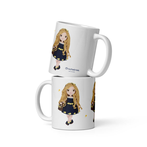 Two stacked Crochetree mugs with long haired doll in navy lemon dress print and Crochetree logo