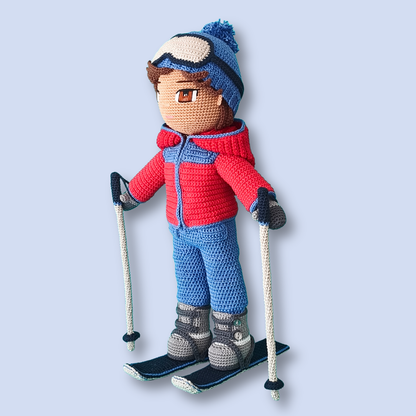 Thomas Skier crochet doll pattern, three quarter view with skis and poles
