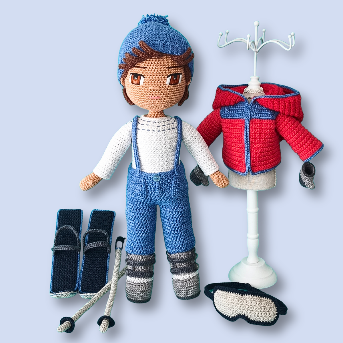 Thomas Skier crochet doll pattern with ski jacket on display stand