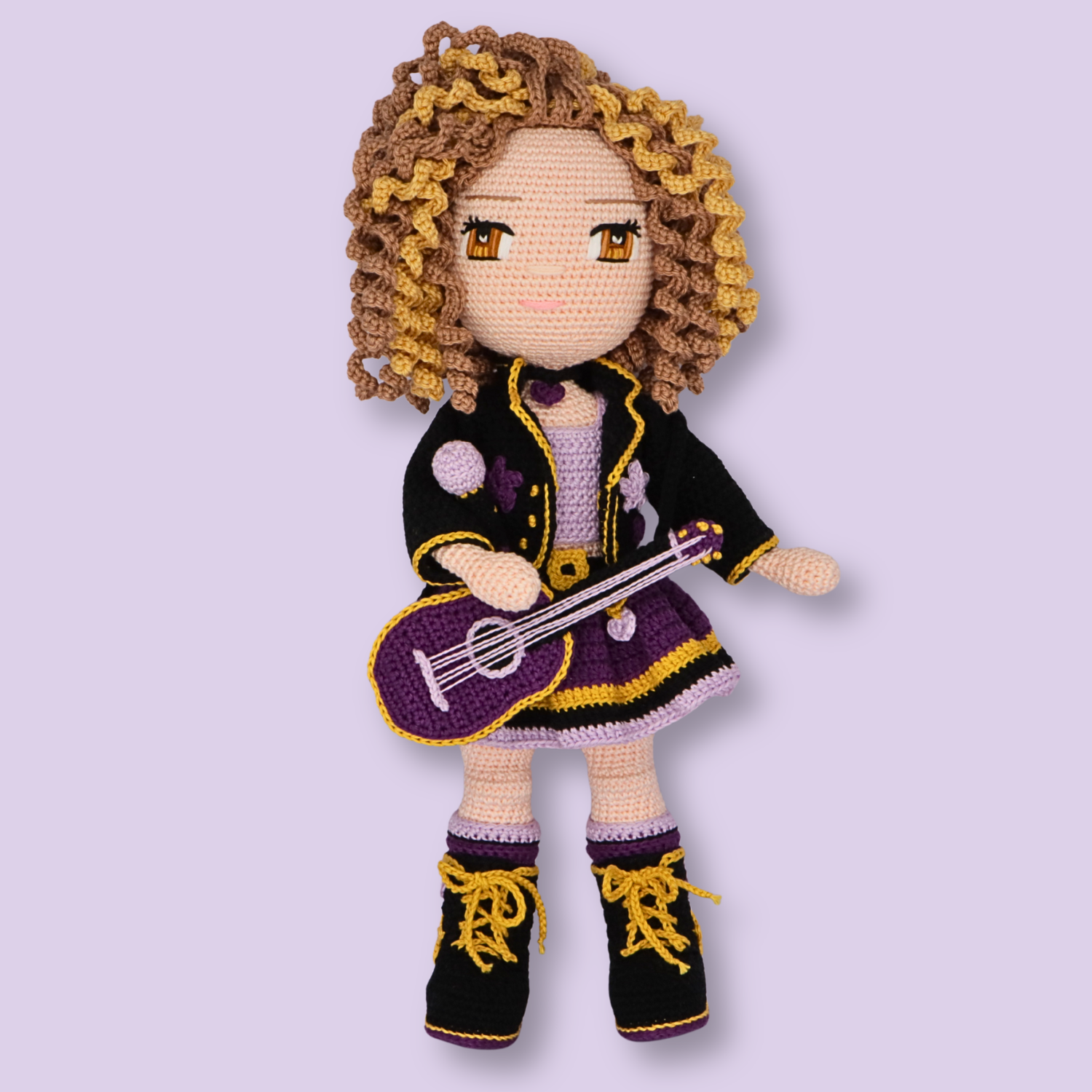 Alice crochet doll pattern - front view of amigurumi doll with curly blonde hair, black jacket, and purple guitar