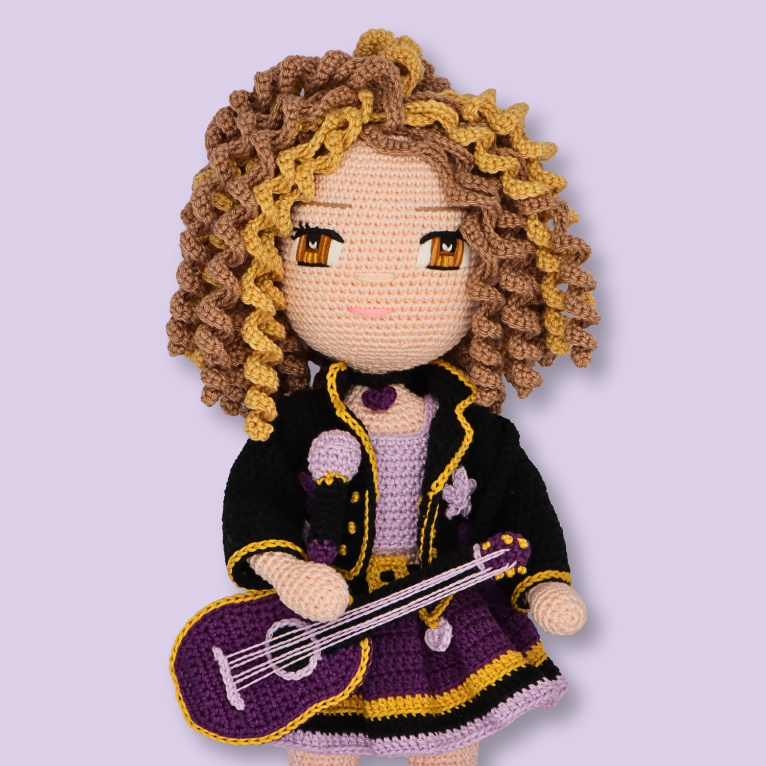 Close-up of Alice crochet doll's embroidered amber eyes and corkscrew curls - amigurumi pattern by Crochetree