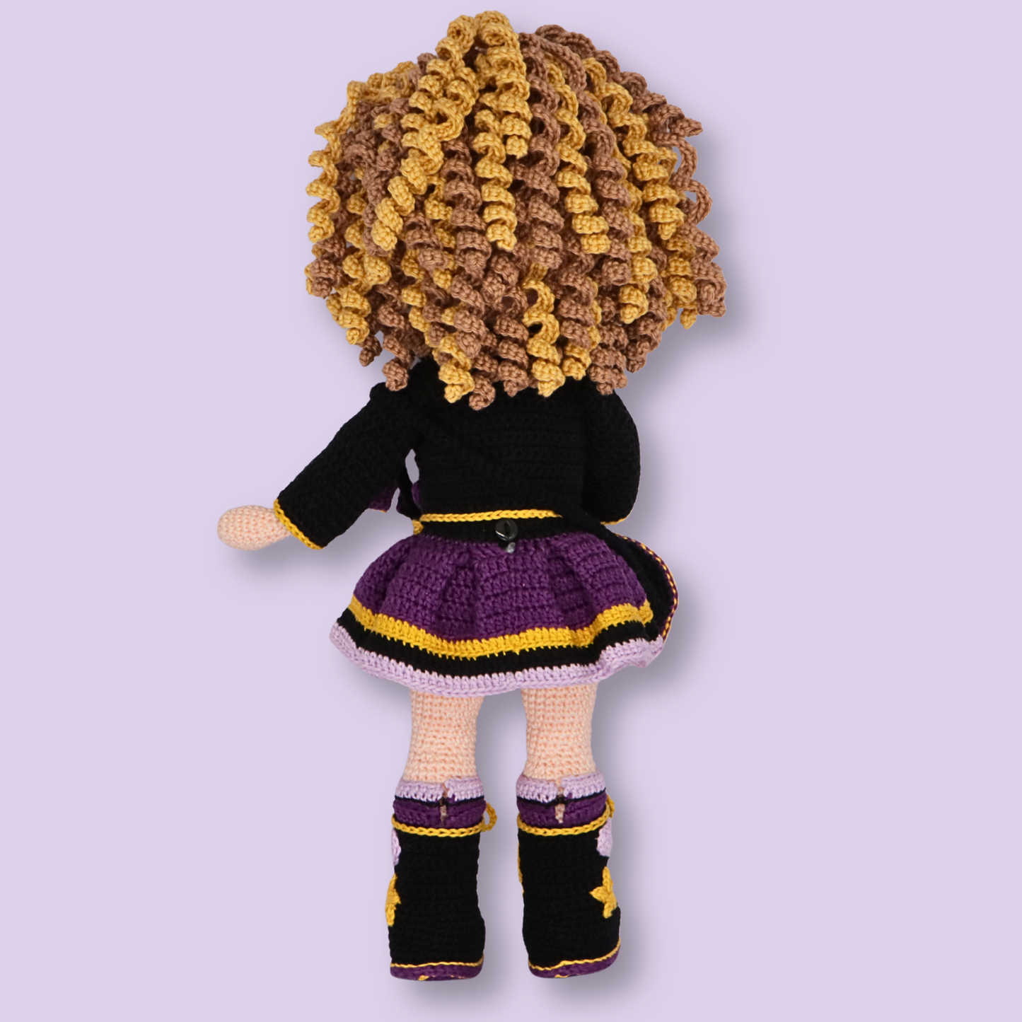 Back view of Alice crochet doll showing curly hair and layered purple skirt - amigurumi pattern