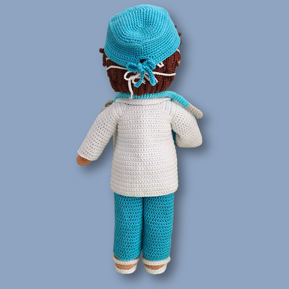 Back view of Dr. Thomas crochet doll showing tied scrub cap over brown hair and white lab coat