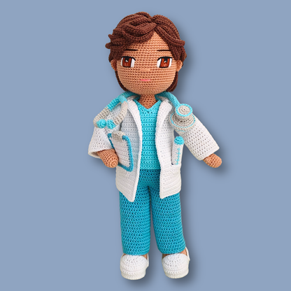 Dr. Thomas doctor crochet doll without cap, showing wavy brown hair, embroidered eyes, and open lab coat
