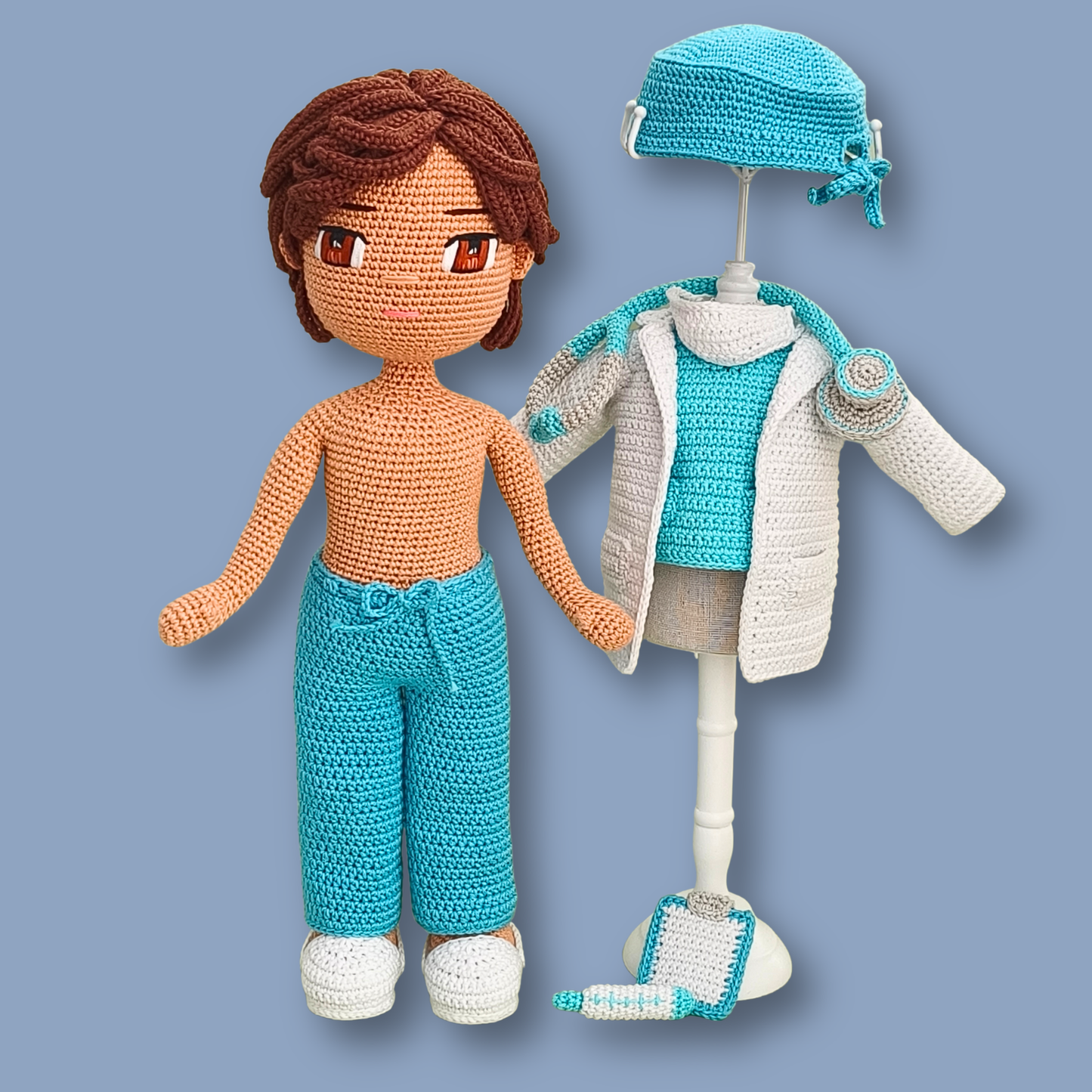 Dr. Thomas base crochet doll in turquoise pants beside a mannequin dressed in scrub top, lab coat, and cap