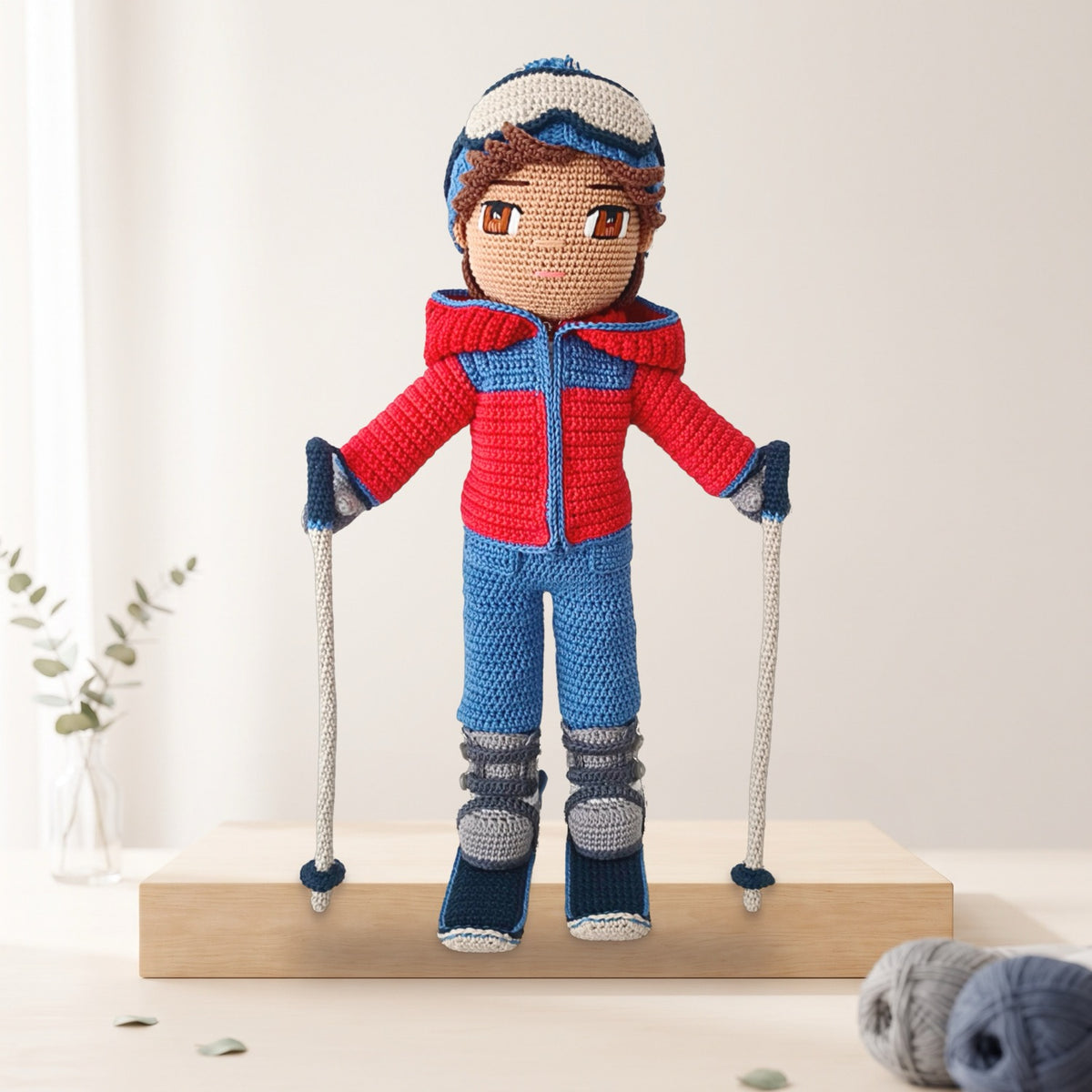 Thomas Skier crochet doll pattern PDF, finished doll in red ski jacket with poles
