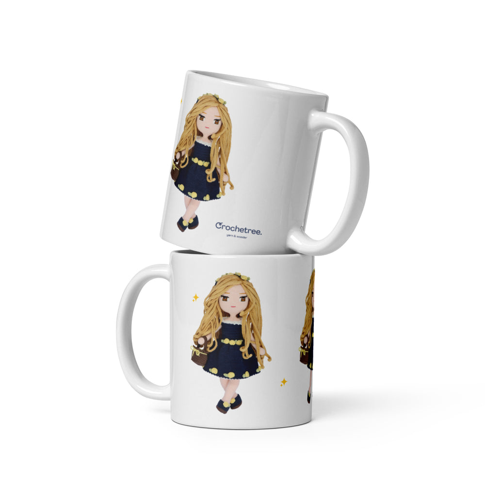 Two stacked Crochetree mugs with long haired doll in navy lemon dress print and Crochetree logo