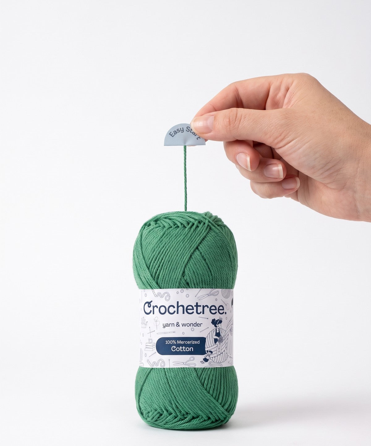A hand pulling the Easy Start tab, drawing the strand out of the center of a green Crochetree skein
